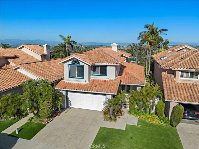 30252 Sonrisa Ln, Laguna Niguel, CA 92677 - mediterranean / spanish house featuring a tiled roof, driveway, an attached garage, stucco siding, and a front yard