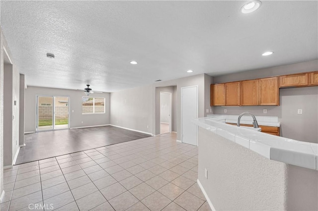 3057 Kilt Ct, Lancaster, CA 93535 - kitchen featuring a ceiling fan, recessed lighting, light tile patterned floors, baseboards, and open floor plan