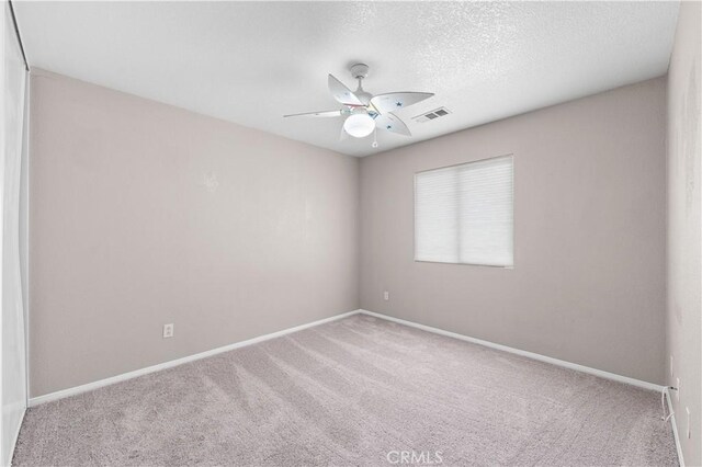 3057 Kilt Ct, Lancaster, CA 93535 - carpeted spare room featuring ceiling fan, baseboards, and a textured ceiling
