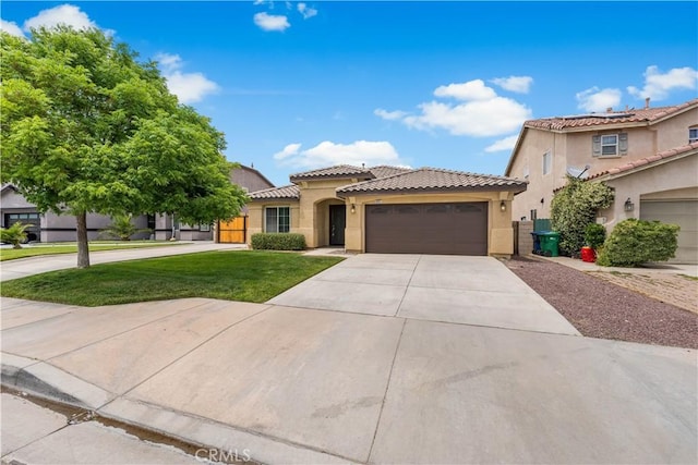 3057 Kilt Ct, Lancaster, CA 93535 - mediterranean / spanish-style house with stucco siding, concrete driveway, a garage, and a tile roof