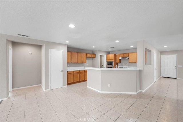 3057 Kilt Ct, Lancaster, CA 93535 - kitchen featuring stainless steel microwave, light countertops, baseboards, and recessed lighting