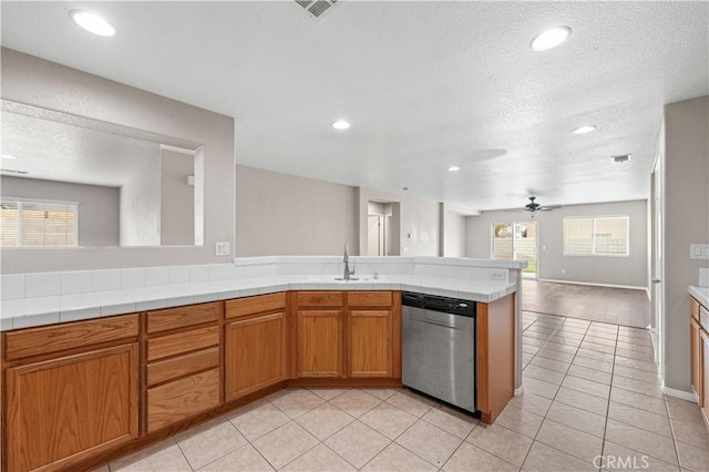 3057 Kilt Ct, Lancaster, CA 93535 - kitchen featuring stainless steel dishwasher, open floor plan, ceiling fan, a textured ceiling, and a sink