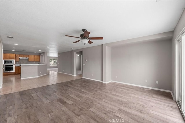3057 Kilt Ct, Lancaster, CA 93535 - unfurnished living room featuring light wood finished floors, ceiling fan, recessed lighting, and baseboards