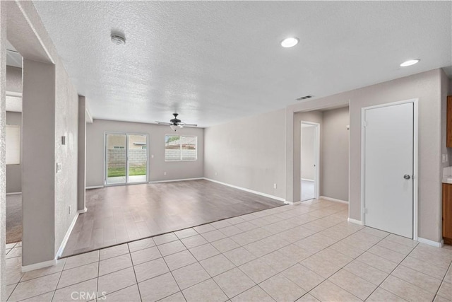 3057 Kilt Ct, Lancaster, CA 93535 - empty room with ceiling fan, a textured ceiling, baseboards, light tile patterned floors, and recessed lighting