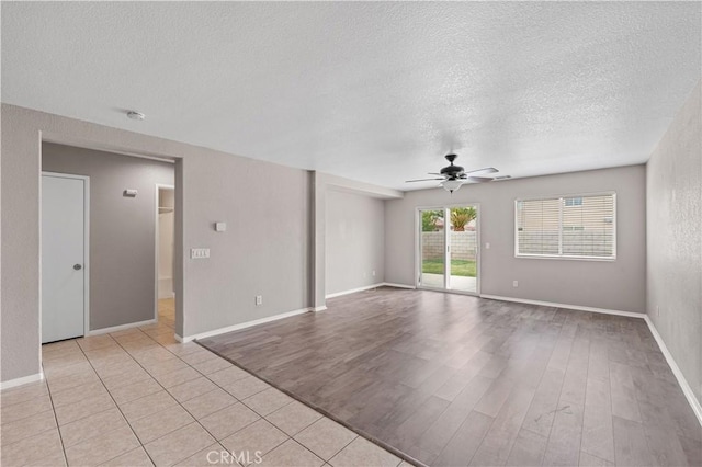 3057 Kilt Ct, Lancaster, CA 93535 - spare room featuring ceiling fan, a textured ceiling, light wood-style flooring, a smoke detector, and baseboards