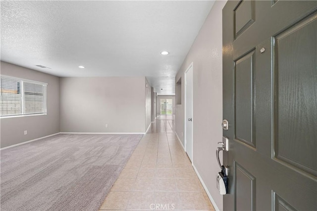 3057 Kilt Ct, Lancaster, CA 93535 - foyer entrance featuring light tile patterned floors, baseboards, recessed lighting, and light carpet