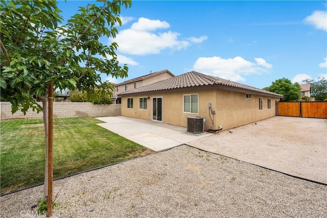 3057 Kilt Ct, Lancaster, CA 93535 - back of property with cooling unit, stucco siding, a tile roof, and a patio area