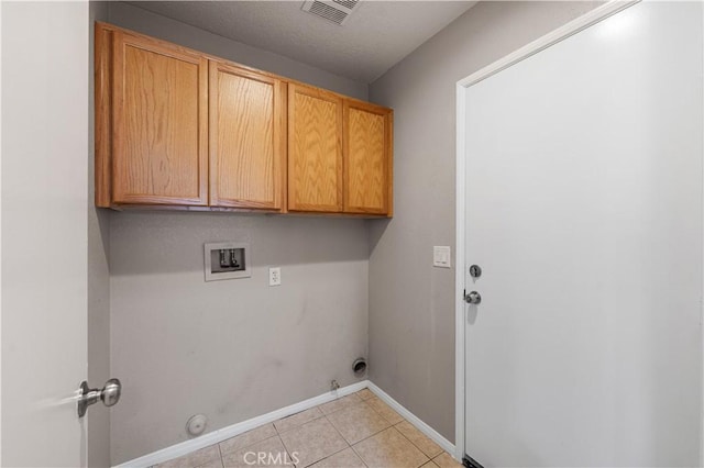 3057 Kilt Ct, Lancaster, CA 93535 - laundry room featuring gas dryer hookup, hookup for a washing machine, cabinet space, baseboards, and light tile patterned flooring