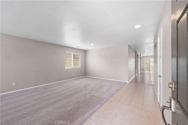 3057 Kilt Ct, Lancaster, CA 93535 - spare room with plenty of natural light, light colored carpet, light tile patterned flooring, baseboards, and a textured ceiling