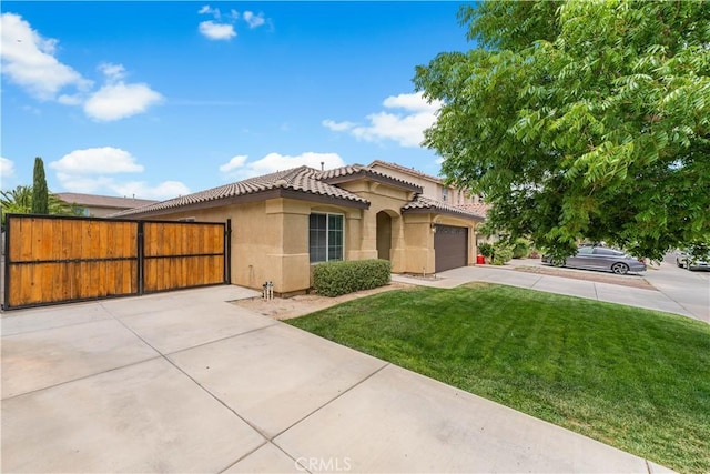 3057 Kilt Ct, Lancaster, CA 93535 - mediterranean / spanish home with stucco siding, a tiled roof, concrete driveway, a garage, and a gate