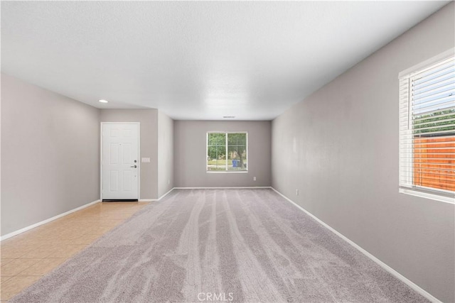 3057 Kilt Ct, Lancaster, CA 93535 - carpeted empty room featuring baseboards, recessed lighting, and tile patterned flooring