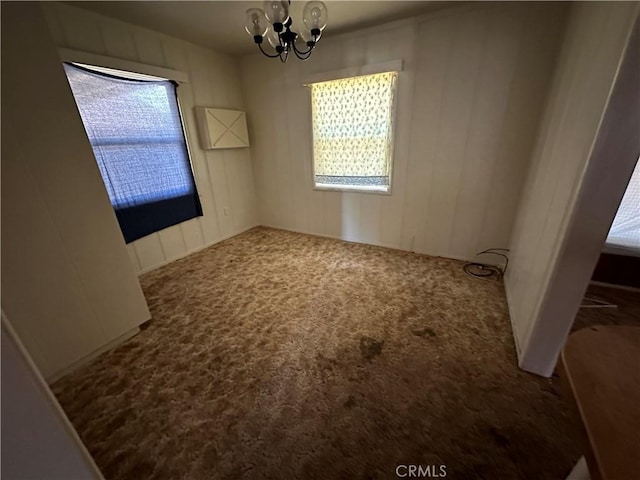 2233 Marguerite St, Dos Palos, CA 93620 - unfurnished dining area featuring carpet flooring and a chandelier