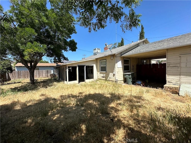 2233 Marguerite St, Dos Palos, CA 93620 - back of house with a sunroom and a chimney