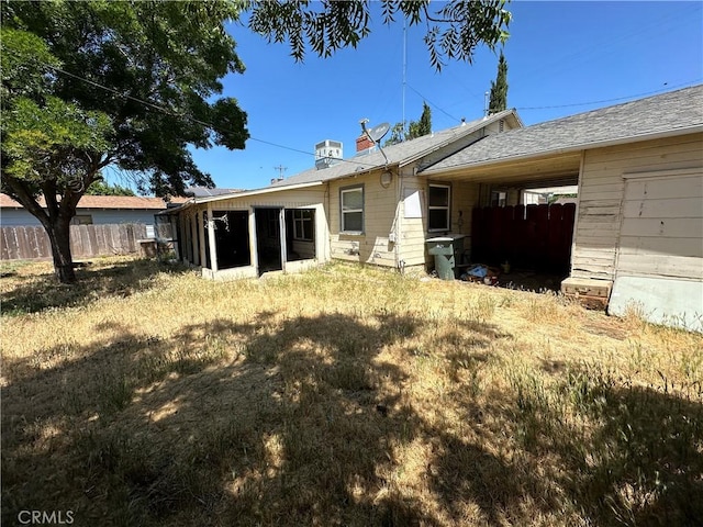 2233 Marguerite St, Dos Palos, CA 93620 - rear view of property featuring a chimney and a sunroom