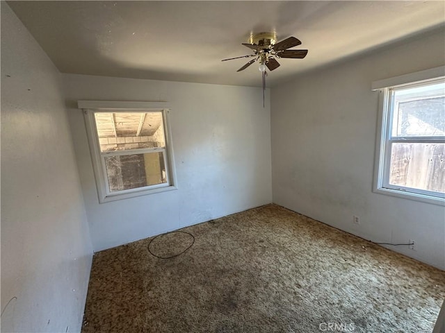 2233 Marguerite St, Dos Palos, CA 93620 - empty room with a ceiling fan and carpet flooring