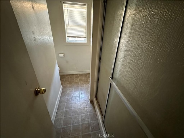 2233 Marguerite St, Dos Palos, CA 93620 - corridor with baseboards and tile patterned flooring