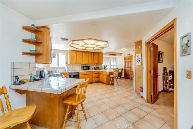 5131 Cygnet Rd A-B, Unit A-B Phelan, CA 92371 - kitchen featuring a peninsula, tasteful backsplash, black appliances, tile countertops, and open shelves