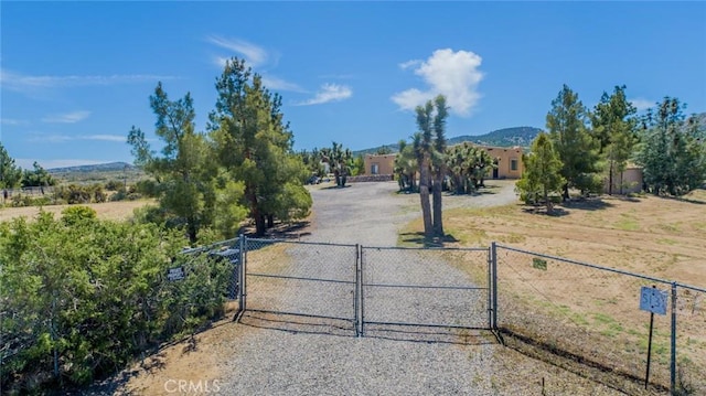 5131 Cygnet Rd A-B, Unit A-B Phelan, CA 92371 - view of dirt / gravel driveway featuring a gate, a gated entry, and a mountain view