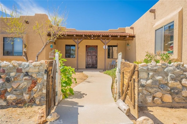 5131 Cygnet Rd A-B, Unit A-B Phelan, CA 92371 - entrance to property with a tiled roof, stucco siding, and a gate
