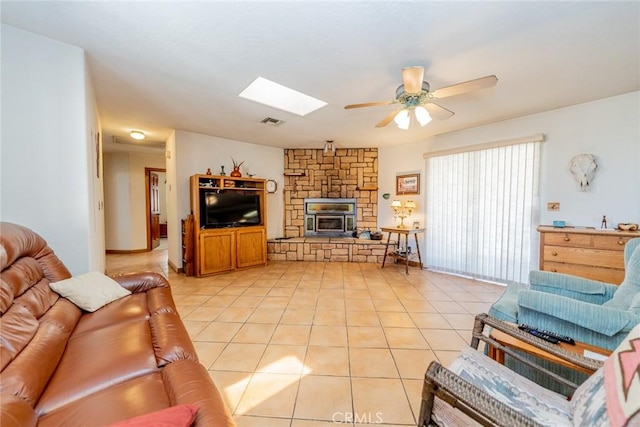 5131 Cygnet Rd A-B, Unit A-B Phelan, CA 92371 - living room with ceiling fan, light tile patterned floors, a skylight, and a stone fireplace