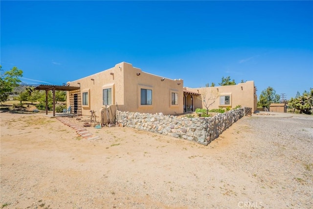 5131 Cygnet Rd A-B, Unit A-B Phelan, CA 92371 - back of property with a pergola and stucco siding