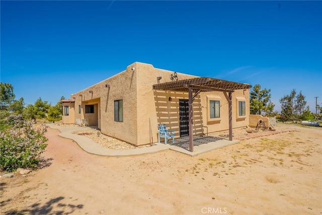 5131 Cygnet Rd A-B, Unit A-B Phelan, CA 92371 - back of house with stucco siding and a pergola