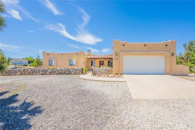 5131 Cygnet Rd A-B, Unit A-B Phelan, CA 92371 - adobe home with stucco siding, driveway, a garage, and a chimney