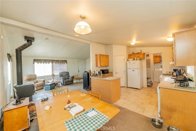5131 Cygnet Rd A-B, Unit A-B Phelan, CA 92371 - dining area with washer / clothes dryer, a wood stove, and light carpet