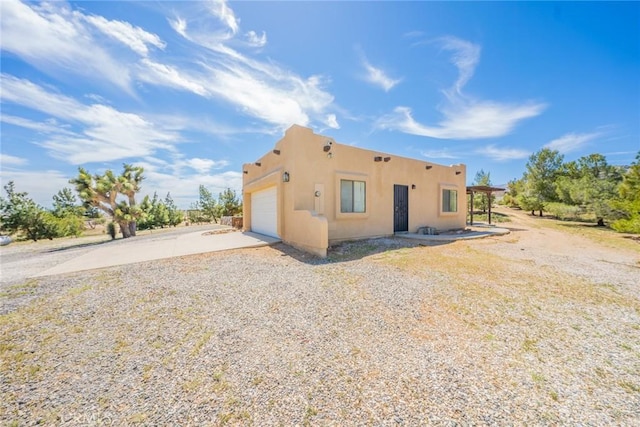 5131 Cygnet Rd A-B, Unit A-B Phelan, CA 92371 - back of property with stucco siding, concrete driveway, and an attached garage