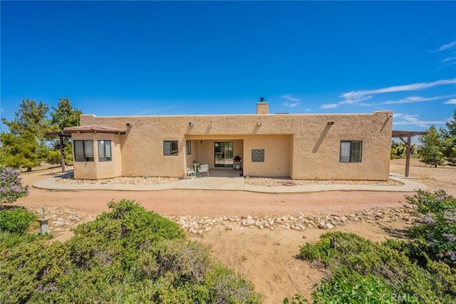 5131 Cygnet Rd A-B, Unit A-B Phelan, CA 92371 - back of house featuring stucco siding, a chimney, and a patio