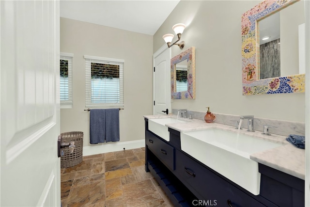 30927 Steeplechase Dr, San Juan Capistrano, CA 92675 - bathroom featuring stone finish flooring, double vanity, and baseboards