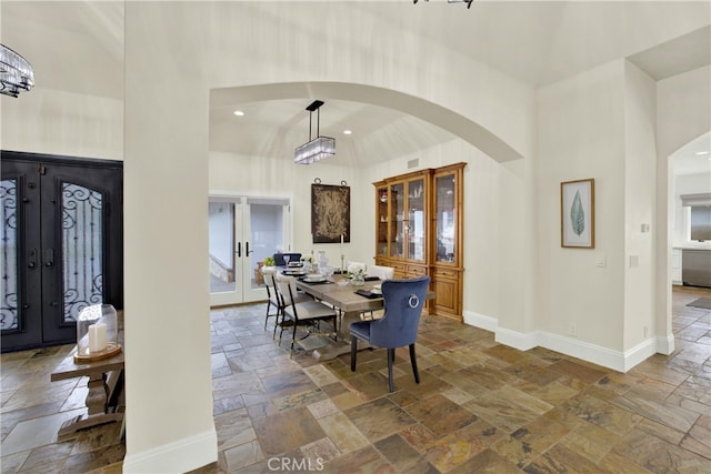 30927 Steeplechase Dr, San Juan Capistrano, CA 92675 - dining space with stone tile flooring, french doors, a high ceiling, arched walkways, and recessed lighting