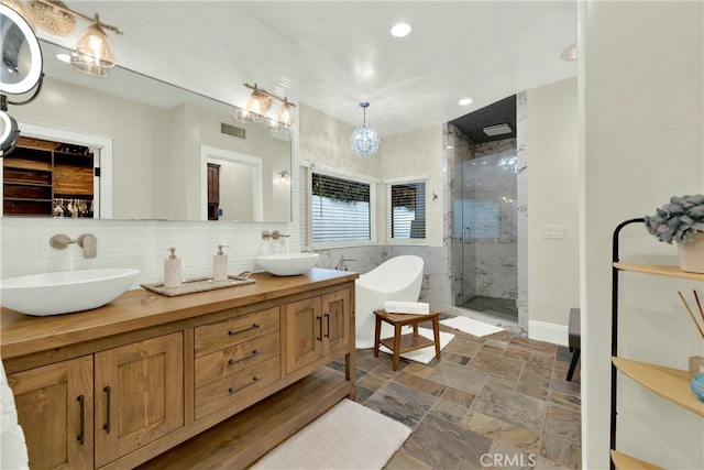 30927 Steeplechase Dr, San Juan Capistrano, CA 92675 - bathroom featuring a shower stall, double vanity, stone finish flooring, a freestanding tub, and recessed lighting