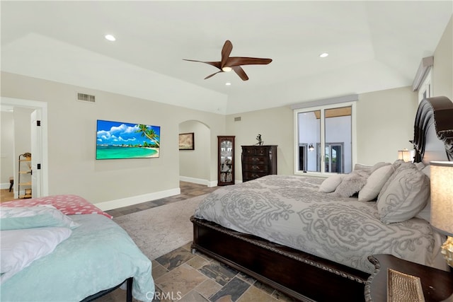 30927 Steeplechase Dr, San Juan Capistrano, CA 92675 - bedroom with arched walkways, baseboards, recessed lighting, a ceiling fan, and stone finish flooring