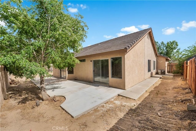 2101 Thomas Dr, Lancaster, CA 93535 - back of property featuring a fenced backyard, stucco siding, a patio, and a tiled roof