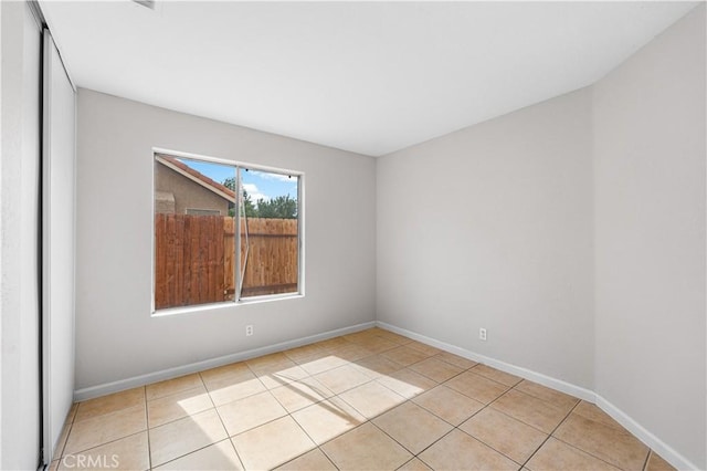 2101 Thomas Dr, Lancaster, CA 93535 - tiled empty room featuring baseboards
