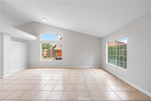 2101 Thomas Dr, Lancaster, CA 93535 - spare room with lofted ceiling, light tile patterned flooring, and baseboards