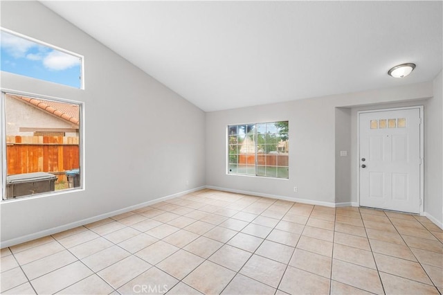 2101 Thomas Dr, Lancaster, CA 93535 - foyer with light tile patterned flooring, lofted ceiling, and baseboards