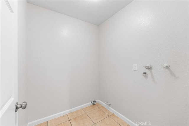 2101 Thomas Dr, Lancaster, CA 93535 - laundry room featuring gas dryer hookup, light tile patterned flooring, and baseboards