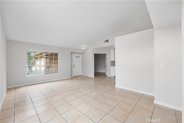 2101 Thomas Dr, Lancaster, CA 93535 - spare room featuring light tile patterned floors, baseboards, and vaulted ceiling