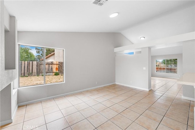 2101 Thomas Dr, Lancaster, CA 93535 - unfurnished room with vaulted ceiling, healthy amount of natural light, light tile patterned floors, and baseboards