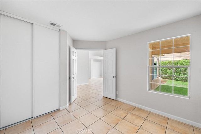 2101 Thomas Dr, Lancaster, CA 93535 - empty room with light tile patterned flooring and baseboards