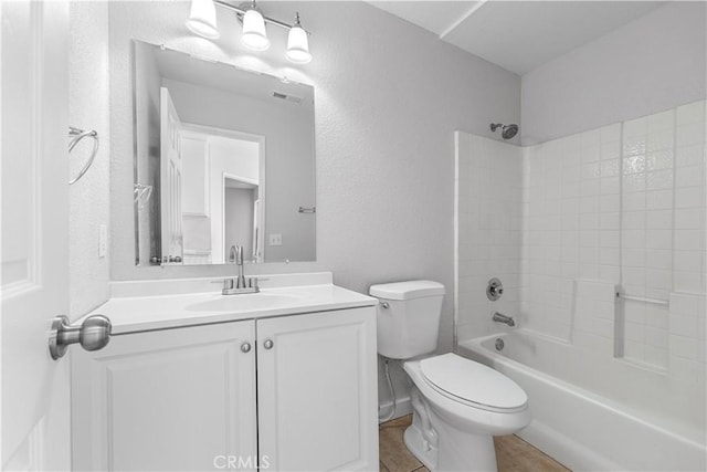 2101 Thomas Dr, Lancaster, CA 93535 - bathroom with vanity, toilet, tub / shower combination, and a textured wall