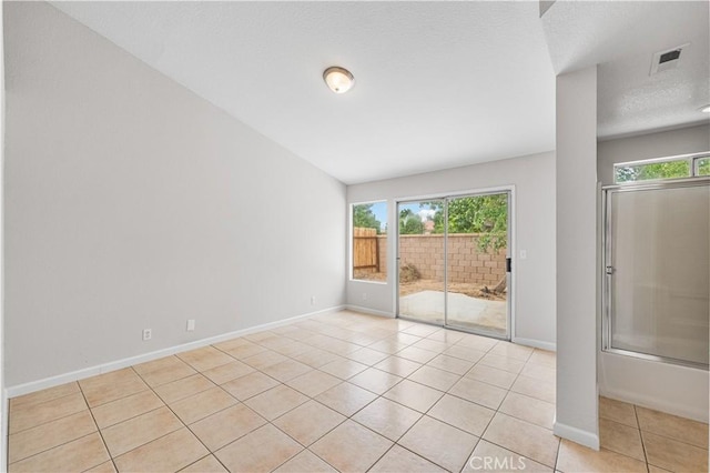 2101 Thomas Dr, Lancaster, CA 93535 - unfurnished room with healthy amount of natural light, light tile patterned floors, baseboards, and a textured ceiling