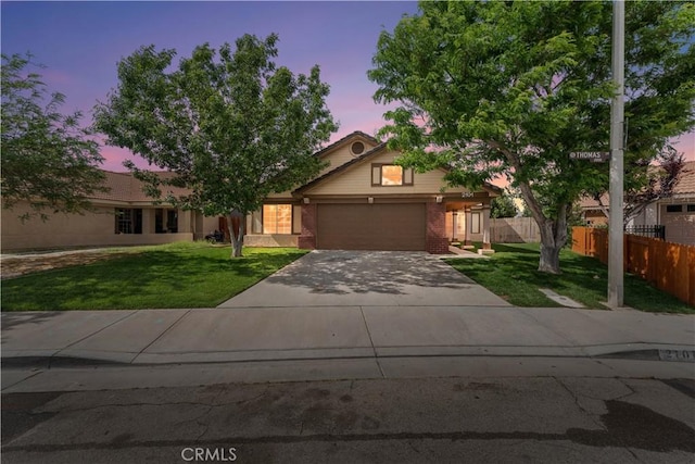 2101 Thomas Dr, Lancaster, CA 93535 - obstructed view of property featuring concrete driveway, an attached garage, and brick siding