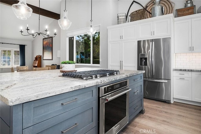 2244 N 1st Ave, Upland, CA 91784 - kitchen with appliances with stainless steel finishes, white cabinetry, light stone counters, and tasteful backsplash