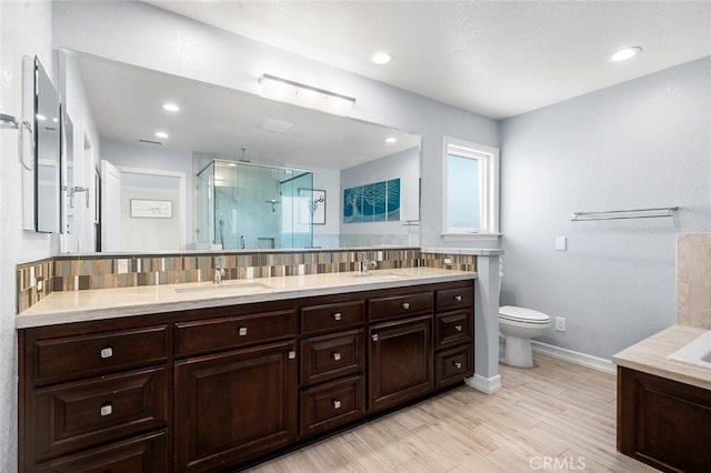 2244 N 1st Ave, Upland, CA 91784 - full bath with a shower stall, vanity, wood finished floors, tasteful backsplash, and recessed lighting