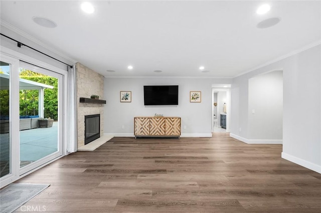 2244 N 1st Ave, Upland, CA 91784 - unfurnished living room featuring crown molding, recessed lighting, a stone fireplace, and wood finished floors