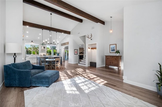 2244 N 1st Ave, Upland, CA 91784 - living room featuring stairs, beam ceiling, a chandelier, wood finished floors, and high vaulted ceiling