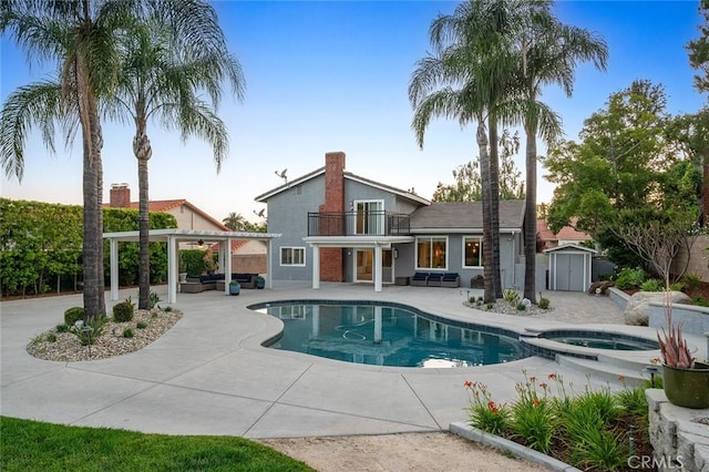2244 N 1st Ave, Upland, CA 91784 - view of pool featuring a storage unit, a patio, a pool with connected hot tub, and an outdoor hangout area